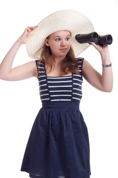 A girl in a big straw hat looking through binoculars on a white background