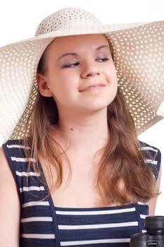 A girl in a big straw hat on a white background