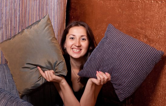 the girl looks out of pillows and coquettish smiles