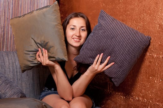 the girl looks out of pillows and coquettish smiles