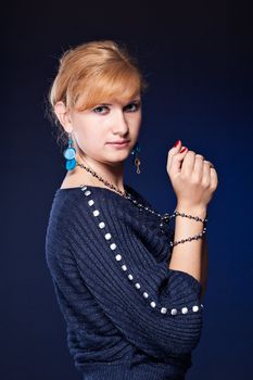 Beautiful girl with tied hands, looks into the camera studio photography