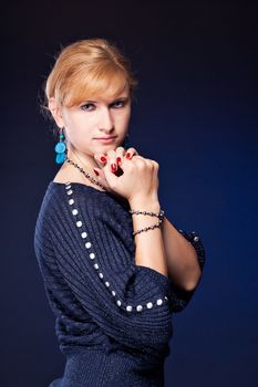 Beautiful girl with tied hands, looks into the camera studio photography