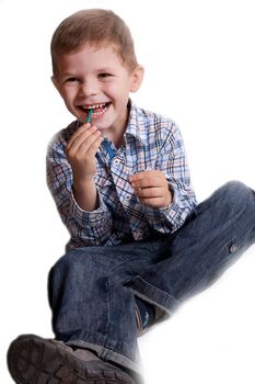 a little boy with candy on a stick studio photography