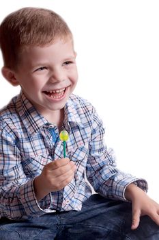 a little boy with candy on a stick studio photography