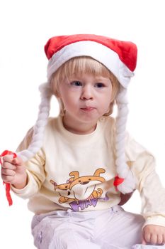 little girl in a Christmas hat with braids on a white background
