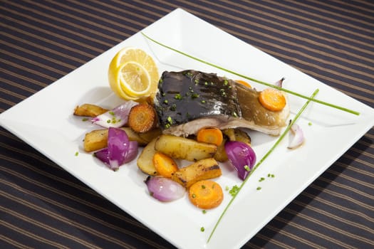 Grilled carp with vegetable garnish