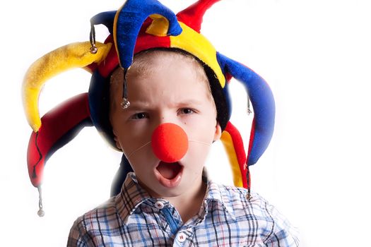 little boy with a clown nose and a cap studio photography