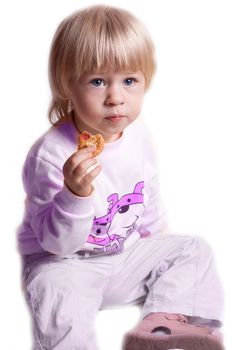 Small girl eating cookies on a white background