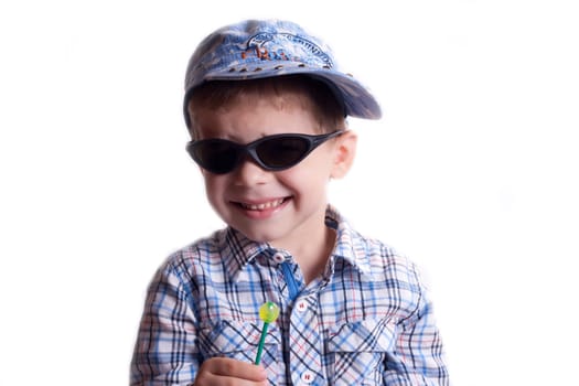 A boy wearing sunglasses and a cap on a white background