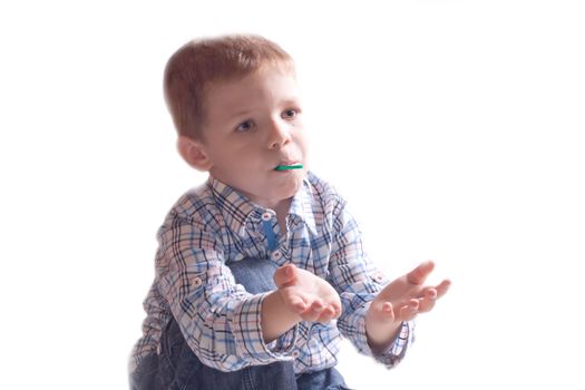 The little boy in a dress with arm outstretched on a white background