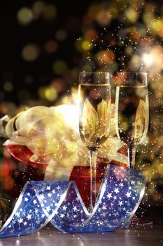 New Year's collage with glasses of champagne. Decorations and ribbons on a bright color background