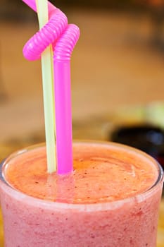 Bright cocktail in a glass tube with a shot in cafe