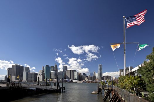 The New York City skyline w the american flag