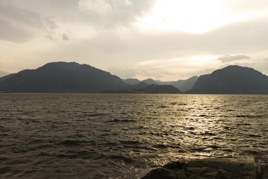 sunset at coast in norway with mountains in background