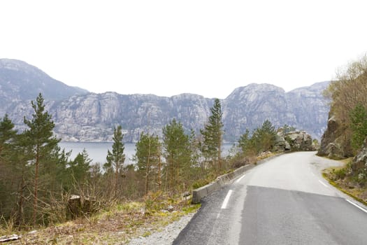 narrow road in rural landscape - norway