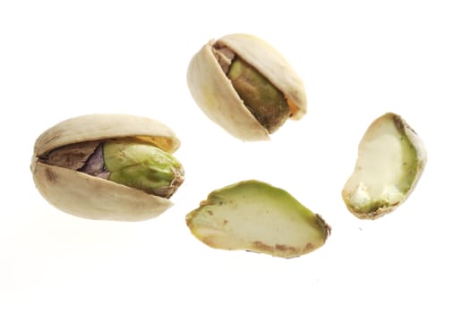The pistachio nuts closeup on white