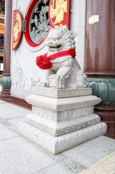 Chinese lion statue at temple, Thailand. Generality in Thailand, any kind of temple, art decorated in Buddhist church, temple etc. created with money donated by people to hire artist. They are public domain, no restrict in copy or use.This photo is taken under these conditions.