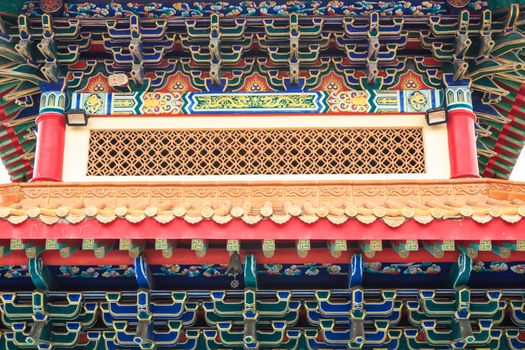 Eaves of Chinese temple, Thailand. Generality in Thailand, any kind of temple, art decorated in Buddhist church, temple etc. created with money donated by people to hire artist. They are public domain, no restrict in copy or use.This photo is taken under these conditions.