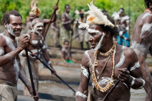 JOW VILLAGE, ASMAT DISTRICT, IRIAN JAYA PROVINCE, NEW GUINEA, INDONESIA - JUNE 28: Group of Asmat with a traditional painting on a face. June 28, 2012 in Jow Village, Asmat, Irian Jaya province, Indonesia