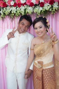 asian thai couple bride and bridegroom in thai wedding suit at wedding ceremony