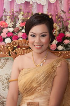 asian thai bride in thai wedding suit smiling in wedding ceremony