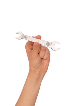 woman holds a small spanner in the hand