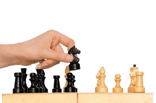 Woman playing chess and making black knight's move
