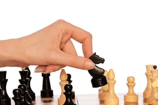 Woman playing chess and making black knight's move