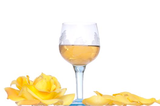 tumbler with white wine and yellow rose on the party