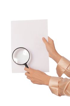 New worker looking at the white blank paperwith a magnifier
