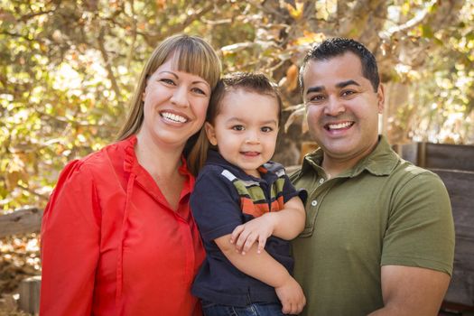 Happy Mixed Race Family Posing for A Portrait in the Park.