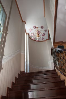 pink lamp decoration above the ladder to up stair