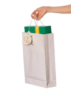 Paper bag with a green box and with a yellow ribbon from the supermarket