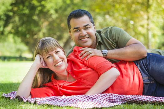 Happy Attractive Mixed Race Couple Portrait on a Blanket at the Park.