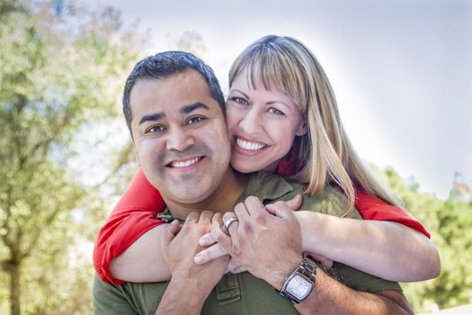 Happy Attractive Mixed Race Couple Piggyback at the Park.