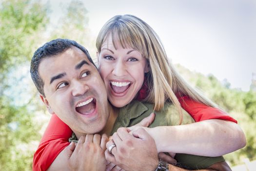 Happy Attractive Mixed Race Couple Piggyback at the Park.