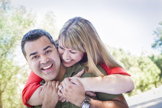 Happy Attractive Mixed Race Couple Piggyback at the Park.