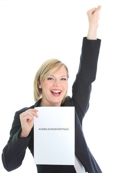 Ecstatic young woman holding up a page of paper or certificate as she punches the air with her fist in jubilation