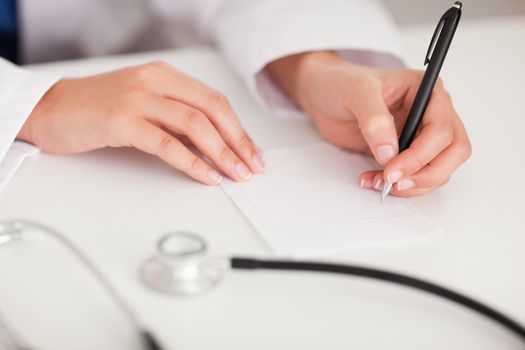 A doctor is writing a note