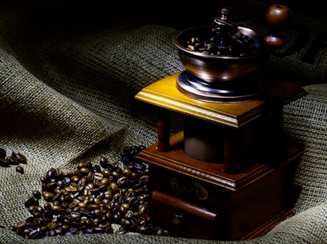 Coffee Mill with beans and burlap, emphasis rays of light