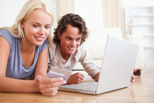 Close up of couple shopping online in their living room