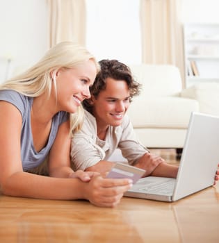 Cute couple purchasing online in their living room