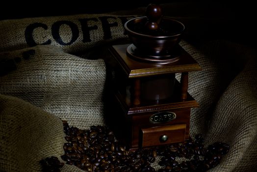 Coffee Mill with beans and burlap, emphasis rays of light