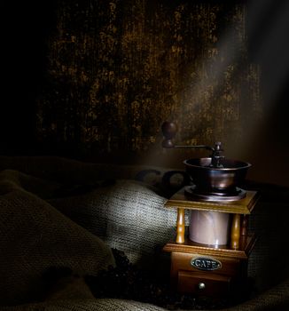 Coffee Mill with beans and burlap, emphasis rays of light