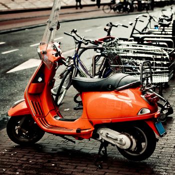 Beautiful picture of a orange vespa in Amsterdam