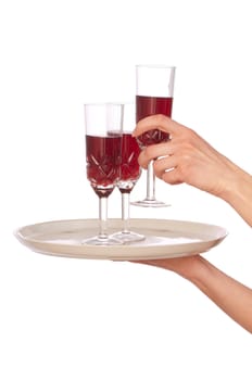 A waiter takes a glass of champagne from a tray with three glasses