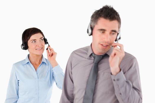 Business people using headsets against a white background