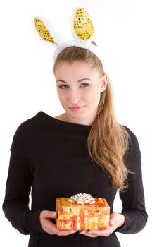 Portrait of a beautiful girl with rabbit ears with a gift in their hands