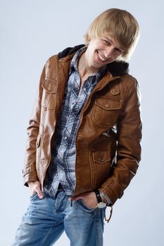 Handsome young man in leather jacket, studio portrait