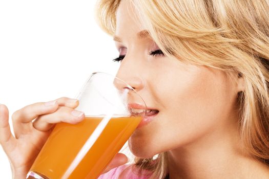 Closeup portrait of a lovely blonde drinking fresh juice